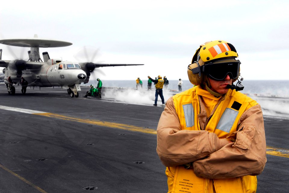 US Navy 080614-N-0684R-078 Chief Aviation Boatswain's Mate (Handling) Christopher Gantz scans the flight deck of the Nimitz-class aircraft carrier USS John C. Stennis (CVN 74)