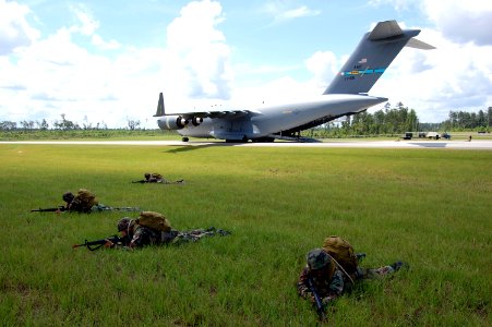 US Navy 080614-N-1057H-207 Sailors assigned to Naval Mobile Construction Battalion (NMCB) 11 set up a secure 360-degree perimeter around the U.S. Air Force C-17 aircraft