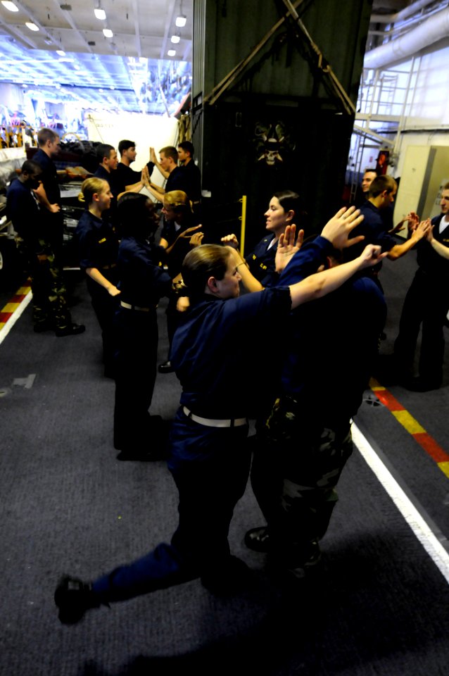 US Navy 080613-N-3659B-308 Master-at-Arms 2nd Class Greg Bonilla is attacked by midshipmen Christi Morrissey, a student at Harvard, during Spontaneous Protection Enabling Accelerated Response (SPEAR) training