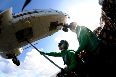 US Navy 080614-N-5961C-002 Storekeeper 2nd Class Staci Bock, a native of Oakland, Calif., prepares to latch a cargo pendant to an AS 332 Super Puma helicopter during a vertical replenishment aboard the aircraft carrier USS Rona