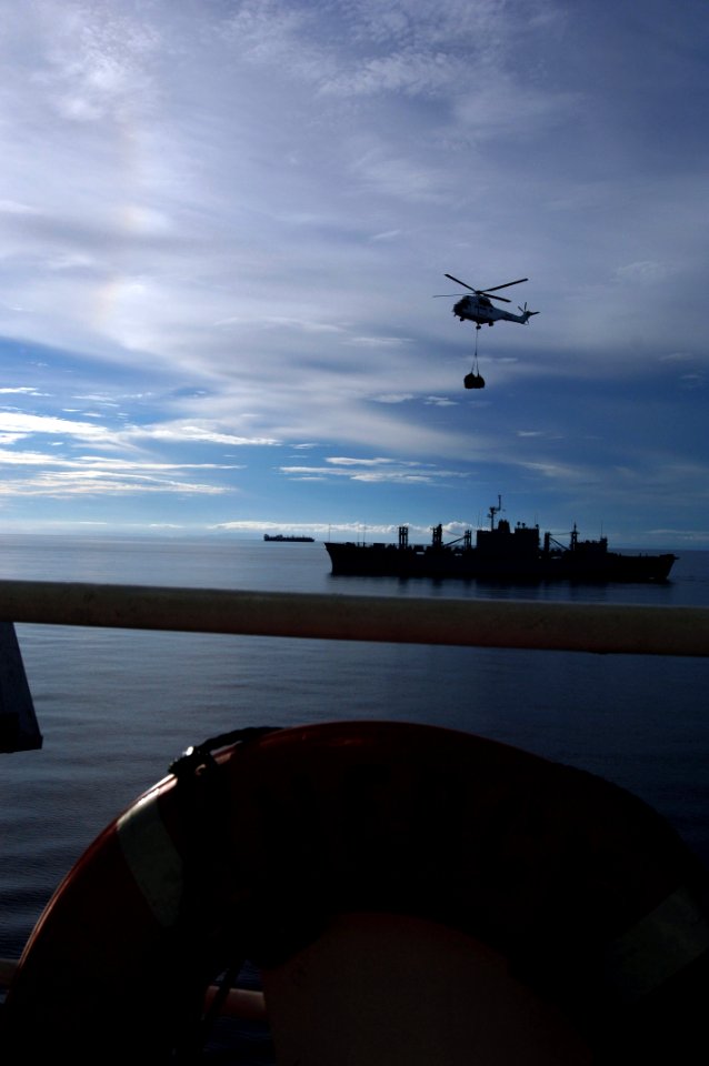 US Navy 080613-N-1450G-116 A helicopter transfers supplies during a vertical replenishment from the Military Sealift Command combat stores ship USNS Concord (T-AFS 5) and the Military Sealift Command hospital ship USNS Mercy (T