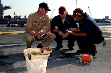 US Navy 080617-N-9774H-003 Damage Controlman 2nd Class Nathan Stachey and Damage Controlman Fireman Nicholas Westrich participate in the sound-powered phone event during the Damage Control Marathon portion of Surface Line Week