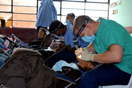US Navy 080615-N-6410J-005 Sailors embarked aboard the amphibious assault ship USS Boxer (LHD 4) perform dental cleanings for patients at the Guillermo Enrique Billinghurst School in Barranca photo