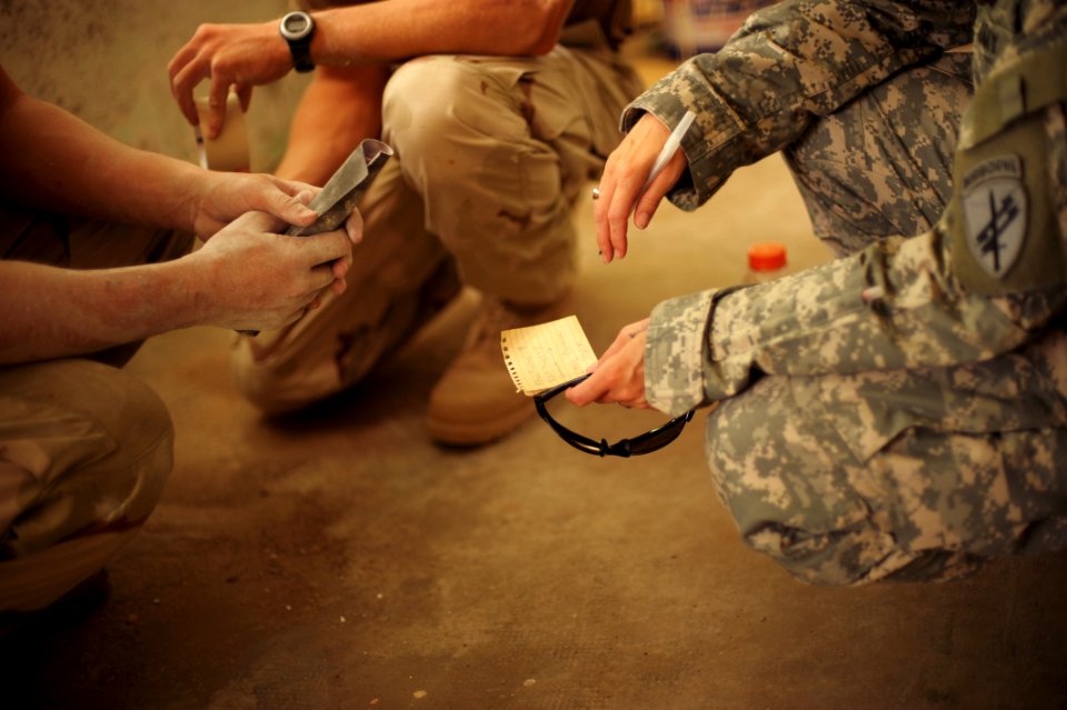 US Navy 080613-N-3674H-003 Seabees assigned to Naval Mobile Construction Battalion (NMCB) 74 discuss the materials needed to paint the Boulaos Middle School 1