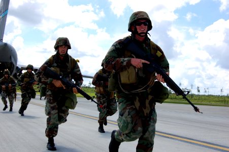 US Navy 080614-N-1057H-191 Yeoman 2nd Class William R. Logsdon III, right, and Steelworker Matthew Pavlinich, along with other members of Naval Mobile Construction Battalion (NMCB) 11, disembark a U.S. Air Force C-17 aircraft