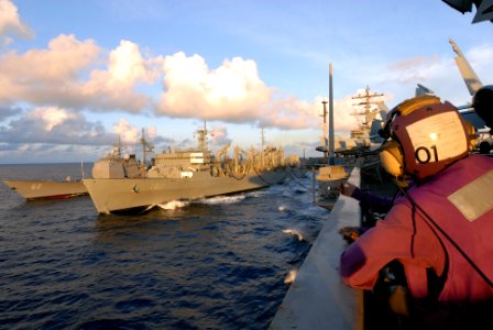 US Navy 080614-N-1635S-005 A Sailor watches as the Ticonderoga-class guided-missile cruiser USS Chancellorsville (CG 62) pulls alongside the Military Sealift Command fleet replenishment oiler USNS Bridge (T-AOE 10) during a rep