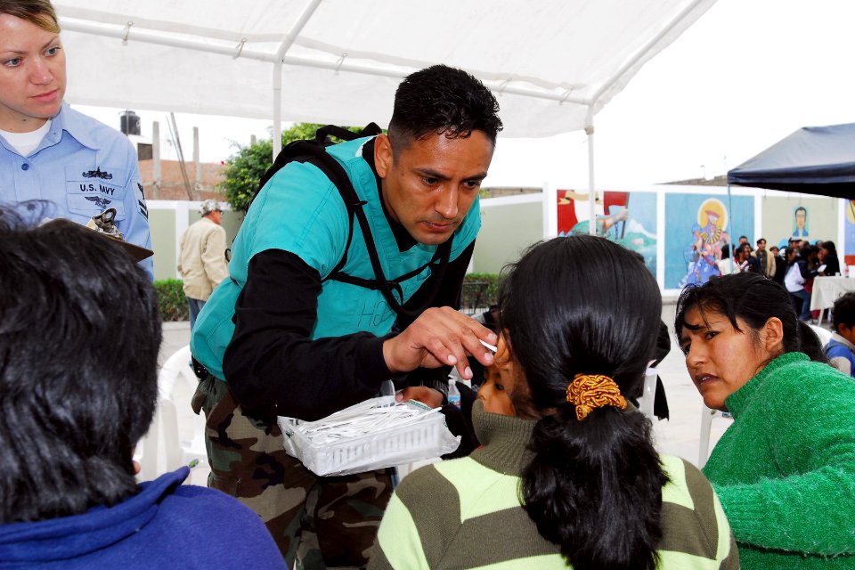 US Navy 080614-N-6410J-024 Hospital Corpsman 1st Class Raul Huerta examines a patient before treatment during a medical civic assistance project at the Guillermo Enrique Billinghurst school in Barranca, Peru