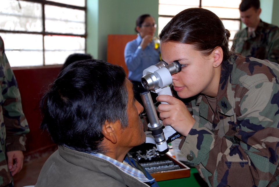 US Navy 080615-N-6410J-024 Lt. Megan Rieman, embarked aboard the amphibious assault ship USS Boxer (LHD 4), examines a patient's eyes at the Guillermo Enrique Billinghurst School in Barranca