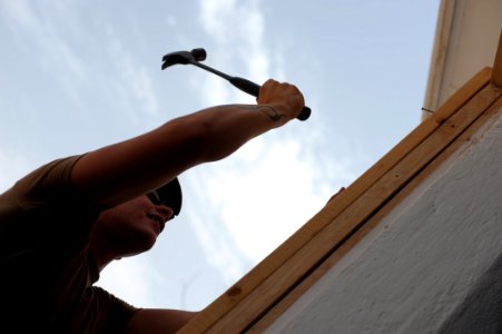US Navy 080616-N-3674H-093 Constructionman Ryan McCarthy, assigned to Naval Mobile Construction Battalion (NMCB) 74, installs a door frame