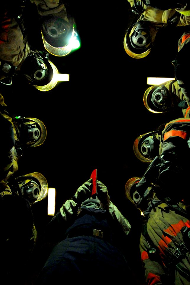 US Navy 080615-N-0684R-027 Sailors discuss firefighting techniques before combating a simulated fire in the hangar bay aboard the Nimitz-class aircraft carrier USS John C. Stennis (CVN 74) during a general quarters drill