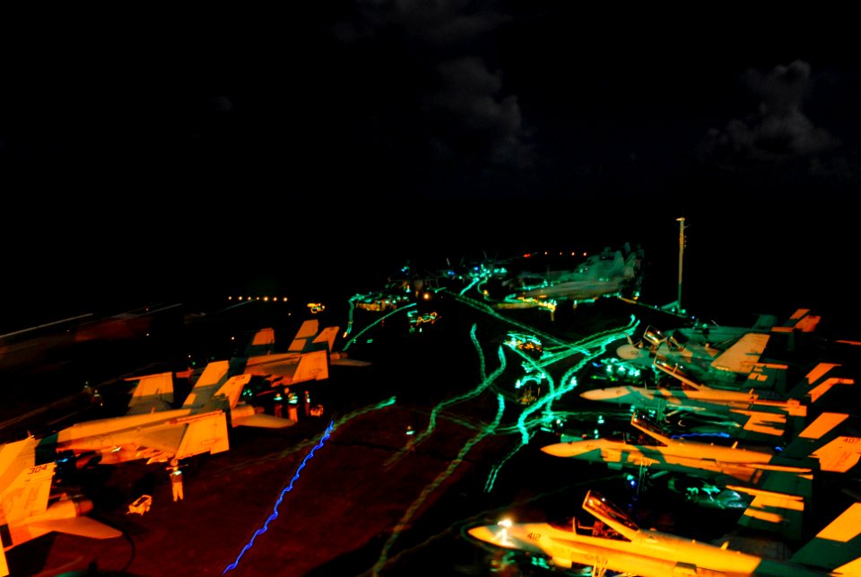 US Navy 080615-N-3946H-062 Sailors reorganize aircraft on the flight deck of the aircraft carrier USS Kitty Hawk (CV 63) after night flight operations. Kitty Hawk typically conducts flight operations over a 12-hour period each