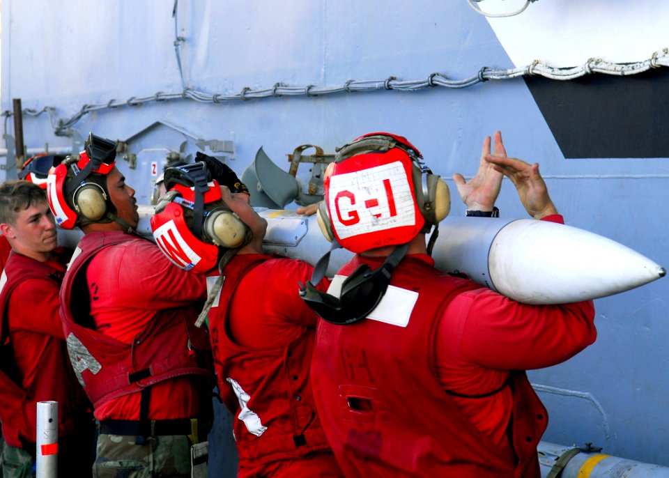 US Navy 080618-N-2638R-001 Sailors move an M-120 advanced medium air-to-air missile aboard the aircraft carrier USS Kitty Hawk (CV 63) during flight operations