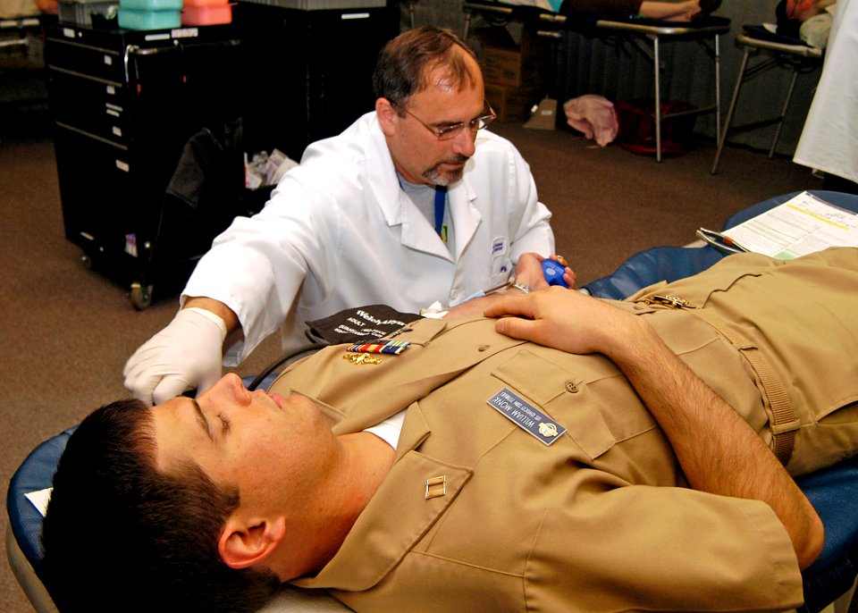 US Navy 080618-N-4649C-003 Steve Rosa, a technician from the Puget Sound Blood Center, draws blood from Lt. William Monk, the damage control assistant for the ballistic-missile submarine USS Kentucky (SSBN 737) Blue Crew