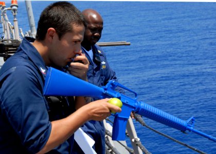 US Navy 080617-N-2838W-031 Sonar Technician Collection 3rd Class Armando Pena communicates essential information from his watch station during a force protection drill aboard the guided-missile destroyer USS Bulkeley (DDG 84)