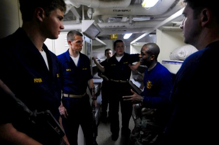 US Navy 080613-N-3659B-023 Information Systems Technician 1st Class Omari Broussard gives close quarter battle training to a group of midshipmen