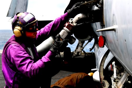 US Navy 080614-N-2610F-018 Aviation Boatswain's Mate (Fuel) Airman Scotty McMahon refuels an F-A-18C Hornet assigned to the