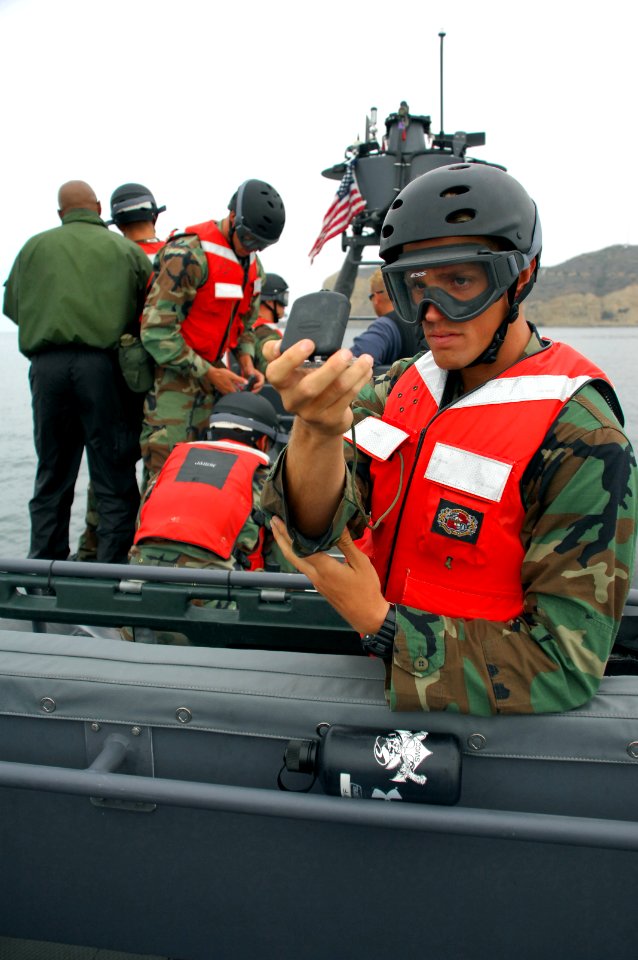 US Navy 080613-N-5366K-149 A Special Warfare Combatant-craft Crewman student takes a directional bearing from an 11-meter rigid hull inflatable boat photo