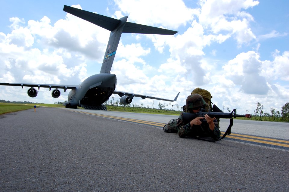 US Navy 080614-N-1057H-195 Sailors assigned to Naval Mobile Construction Battalion (NMCB) 11 set up a secure 360-degree perimeter around the U.S. Air Force C-17 aircraft