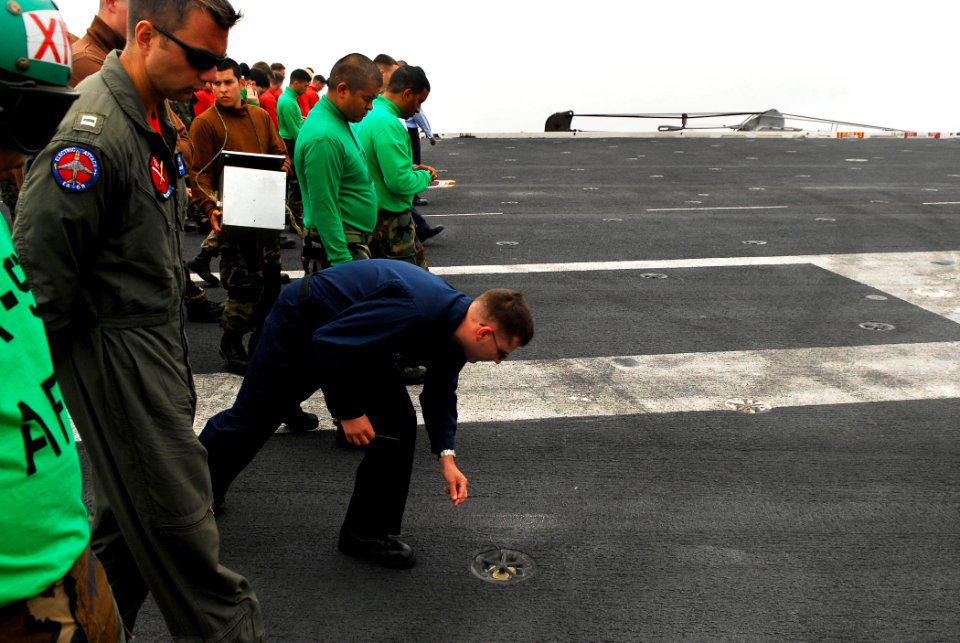 US Navy 080619-N-2610F-011 Sailors search the flight deck for foreign object debris (FOD) during a FOD walkdown aboard the Nimitz-class aircraft carrier USS John C. Stennis (CVN 74)