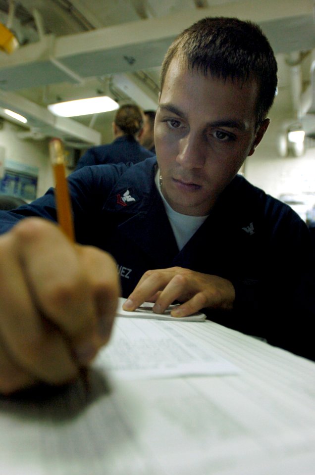US Navy 080618-N-1038M-038 Aerographer's Mate 2nd Class Kristopher Rodriguez, a native of Baltimore, Md., writes a weather report in the meteorology and oceanography center of the aircraft carrier USS Kitty Hawk (CV 63)