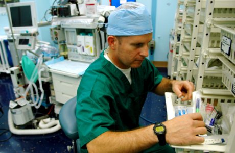 US Navy 080619-N-1328S-001 Cmdr. Trent Douglas, a staff plastic surgeon assigned to the Military Sealift Command hospital ship USNS Mercy (T-AH 19), sorts through surgical equipment before scheduled shipboard surgeries