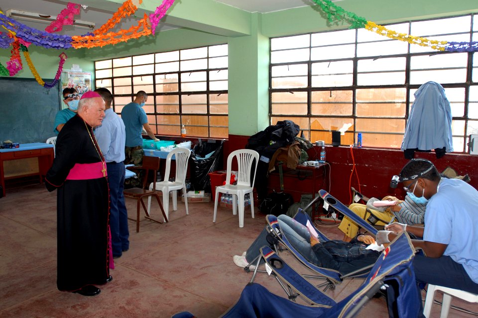 US Navy 080615-N-6410J-046 Peruvian religious leader, the Rev. Antonio Santasiero Rosa, watches as Sailors assigned to the amphibious ship USS Boxer (LHD 4)