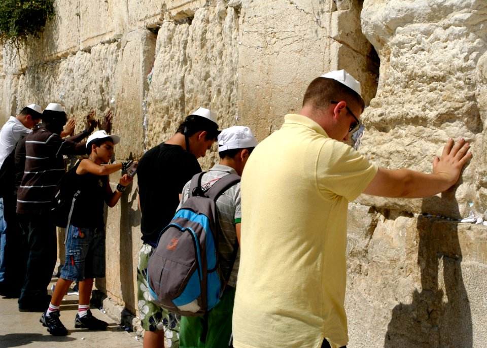 US Navy 080618-N-3316L-232 Yeoman 3rd Class Douglas Pomeroy, assigned to USS Nashville (LPD 13), bows his head and says a prayer at the Western Wall near the end of an MWR-sponsored tour of Jerusalem during a port visit to Haif