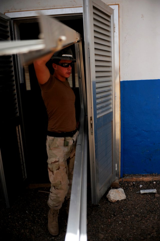 US Navy 080616-N-3674H-045 Constructionman Ryan McCarthy, assigned to Naval Mobile Construction Battalion (NMCB) 74, installs a door frame at a school in Holl Holl as part of a civic affairs project