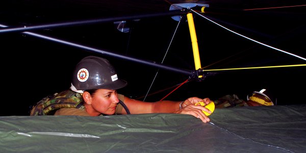 US Navy 080620-N-4973M-015 Yeomen 2nd Class Jennifer Green, assigned to Amphibious Construction Battalion (ACB) 1, fastens together a Base-X tent in Camp Peguero