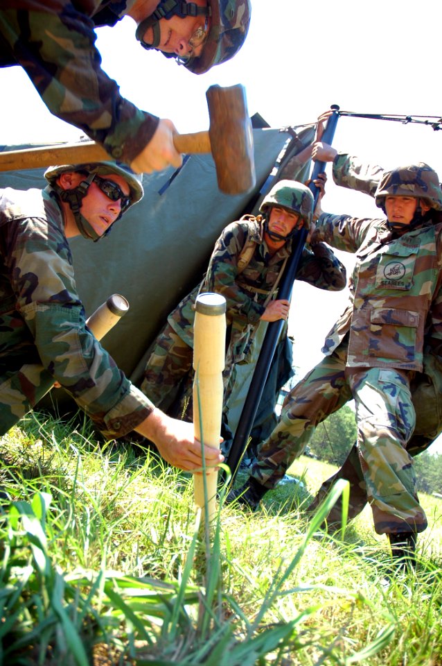 US Navy 080623-N-7367K-001 Seabees assigned to Naval Mobile Construction Battalion (NMCB) 7 work together to erect a field tent at during a field exercise (FEX) at Camp Shelby
