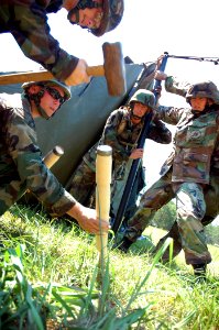 US Navy 080623-N-7367K-001 Seabees assigned to Naval Mobile Construction Battalion (NMCB) 7 work together to erect a field tent at during a field exercise (FEX) at Camp Shelby photo