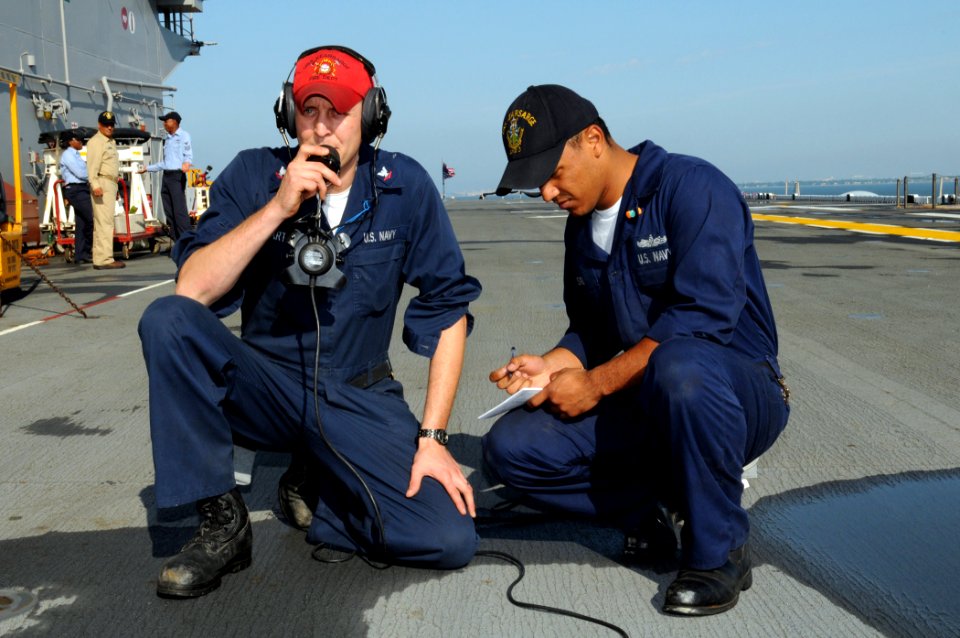 US Navy 080617-N-9774H-008 Damage Controlman 3rd Class Joseph Martin and Damage Controlman Fireman Brayand Osorio participate in the sound-powered phone event during the Damage Control Marathon portion of Surface Line Week 2008
