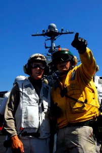 US Navy 080621-N-0684R-012 Lt. Cmdr. Peter Salvaggio explains flight deck operations to University of Southern California (USC) head football Coach, Pete Carroll on the flight deck aboard the Nimitz-class aircraft carrier USS J
