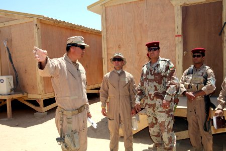 US Navy 080620-N-9623R-232 Lt. Scott Bender, from Casa Grande, Ariz., assigned to Naval Mobile Construction Battalion (NMCB) 17, gives members of the Iraqi Army a tour of the newly completed combat outpost located in the Iraqi