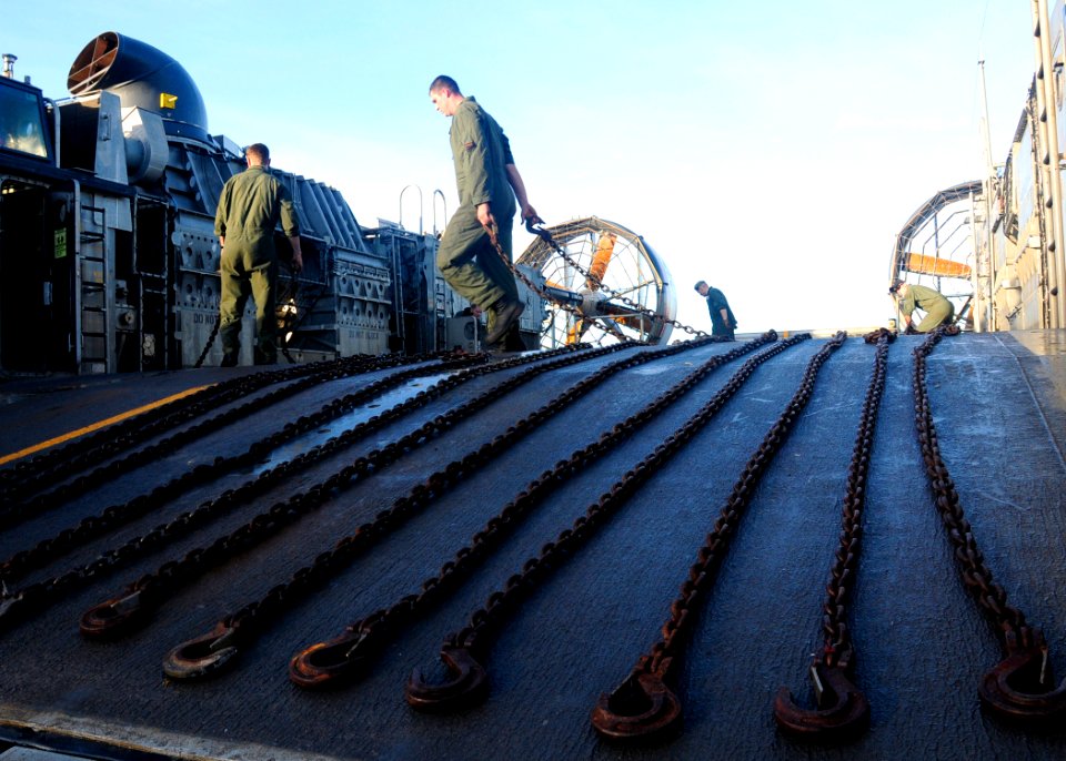 US Navy 080621-N-5067K-122 Crewmembers of a landing craft air cushioned clean the craft and stow retaining chains after disembarking vehicles and equipment from elements of the 31 MEU that were embarked aboard USS Harpers Ferry