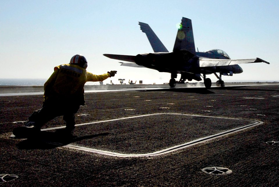 US Navy 080622-N-0684R-087 Lt. Cmdr. William Bassett, an aircraft launching officer, signals the launch of an F-A-18C Hornet on the flight deck of the Nimitz-class aircraft carrier USS John C. Stennis (CVN 74)