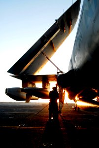US Navy 080620-N-6538W-098 Aviation Electronics Technician 3rd Class Stephen Guz tightens tie-down chains on an EA-6B Prowler following flight operations aboard the aircraft carrier USS John C. Stennis (CVN 74)