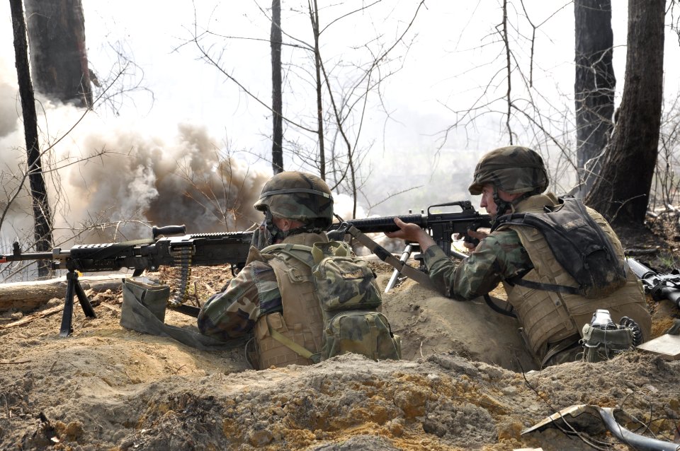 USN Seabees man a machine gun and M-16 rifle during exercise.