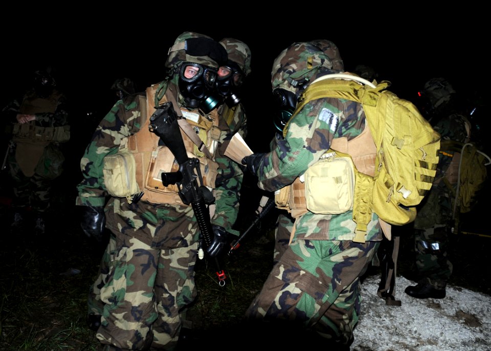 US Navy 080623-N-1120L-086 eabees assigned to Naval Mobile Construction Battalion (NMCB) 7 conduct buddy checks and report in during a simulated chemical attack