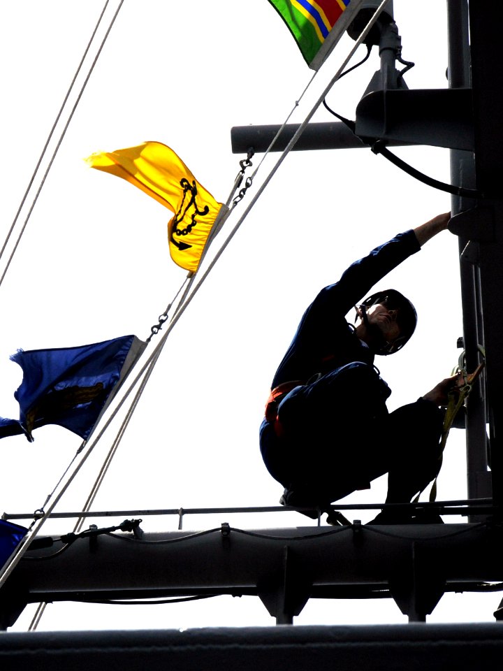 US Navy 080624-N-8546L-038 An inspector from the Yokosuka Naval Base Ship Repair Facility goes aloft on the main mast to evaluate the material condition and operation of antennas aboard the amphibious command ship USS Blue Ridg