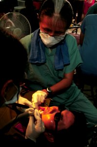 US Navy 080625-N-7498L-160 Cmdr. Monica Rueben, of the U.S. Public Health Service, performs a teeth cleaning on Vietnamese Army Junior Lt. Lam Xuan Hoa as part of the Pacific Partnership dental civic action program