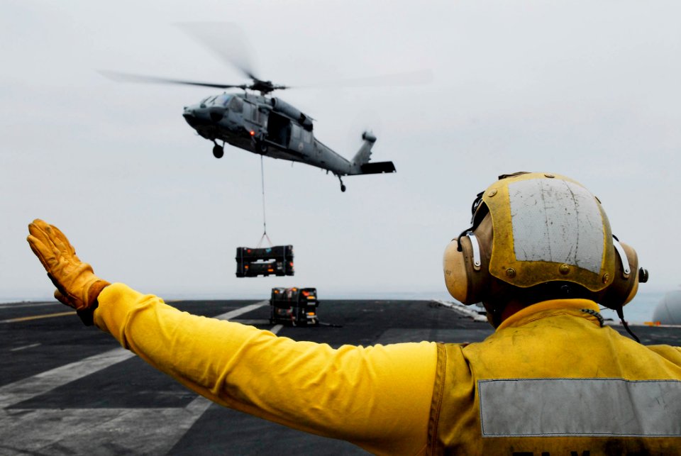 US Navy 080625-N-2610F-034 Aviation Boatswain's Mate (Handling) 3rd Class Kyle Cowell directs an MH-60S Seahawk assigned to the