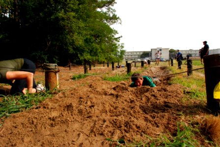 US Navy 080621-N-0193M-715 A 9-year-old boy crawls through a muddy trench at Rudy's SEAL Challenge Cross Country Race
