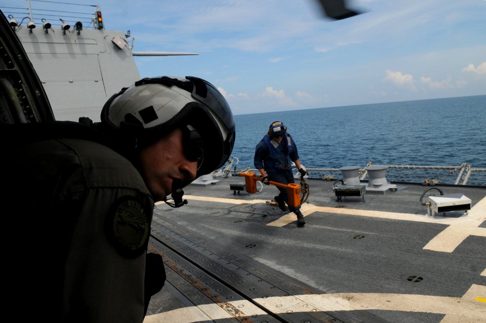 US Navy 080626-N-4009P-364 Aviation Warfare Systems Operator 2nd Class Anthony Chavez, of San Bernardino, Calif., looks out from an SH-60F Seahawk assigned to the