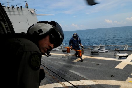 US Navy 080626-N-4009P-364 Aviation Warfare Systems Operator 2nd Class Anthony Chavez, of San Bernardino, Calif., looks out from an SH-60F Seahawk assigned to the
