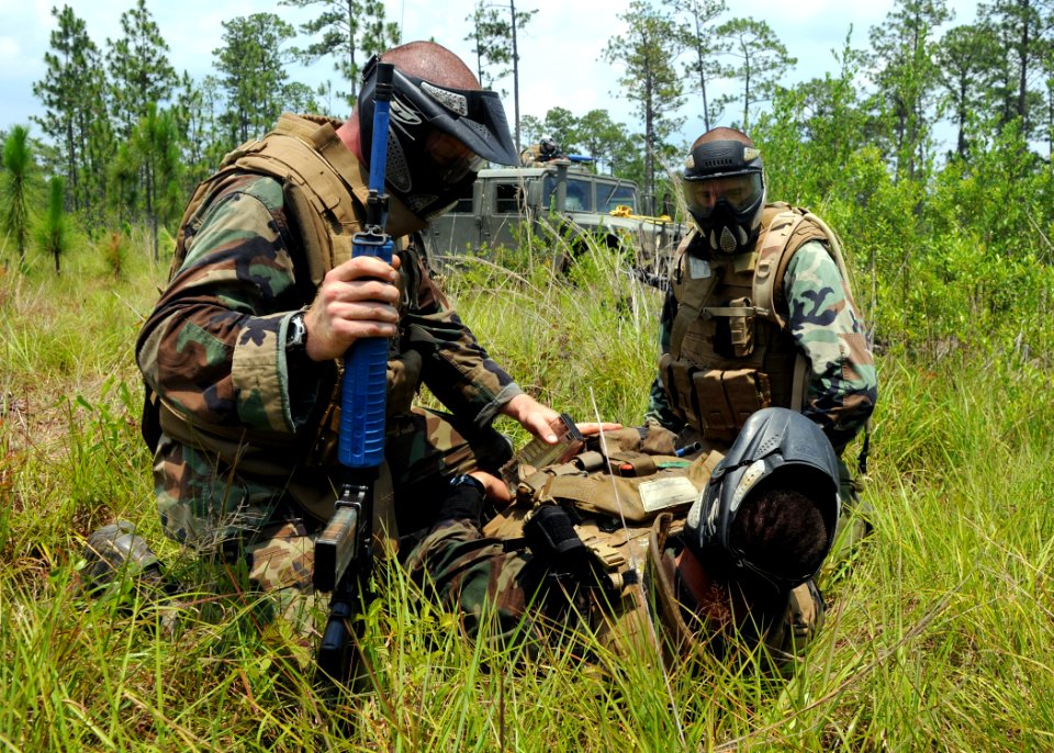 US Navy 080624-N-1120L-045 eabees assigned to Naval Mobile Construction Battalion (NMCB) 7's convoy security element (CSE) teams, conduct first aid on a simulated casualty