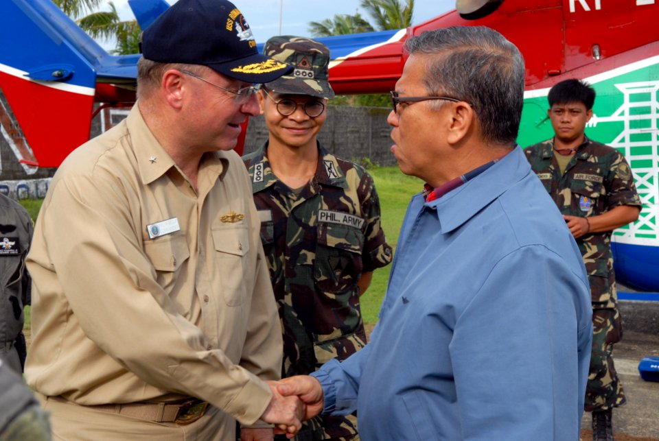 US Navy 080625-N-0640K-026 Rear Adm. James P. Wisecup, left, shakes hands with Angelo Reyes, Secretary of Energy for the Republic of the Philippines