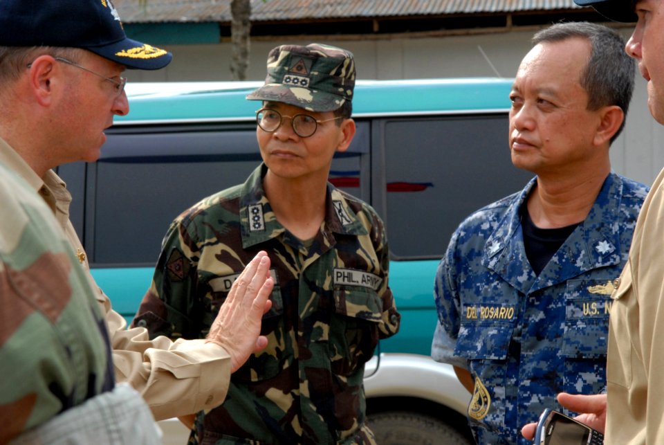 US Navy 080625-N-0640K-023 Rear Adm. James P. Wisecup, left, speaks with Col. Rene David, center, 1st Brigade, 3rd Division commander of the Armed Forces of the Philippines