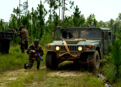 US Navy 080624-N-1120L-013 Seabees assigned to Naval Mobile Construction Battalion (NMCB) 7's convoy security element (CSE) teams move to secure a simulated vehicle in distress
