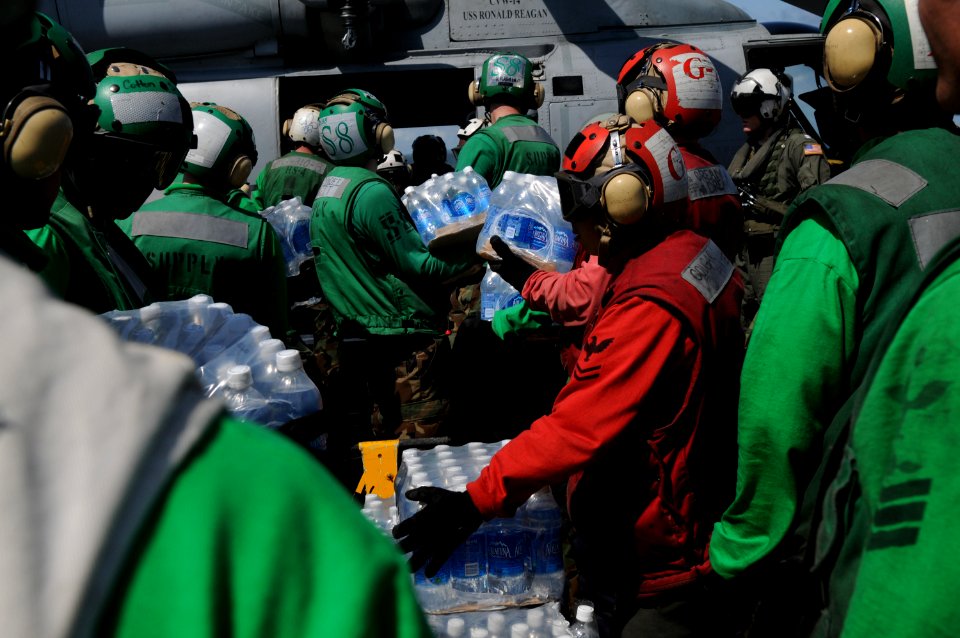 US Navy 080625-N-4009P-873 ailors aboard the Nimitz-class aircraft carrier USS Ronald Reagan (CVN 76) load bottles of water onto an SH-60F Seahawk assigned to the